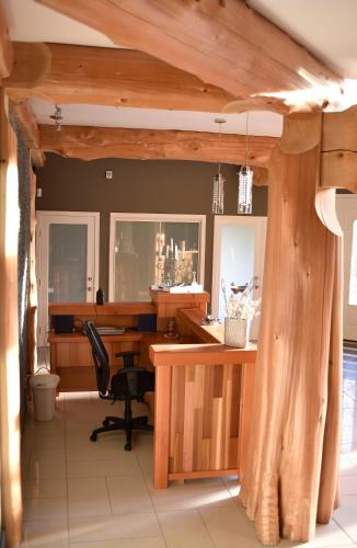 an office with a wooden desk and a chair at The Rockwell-Harrison Guest Lodge in Harrison Hot Springs