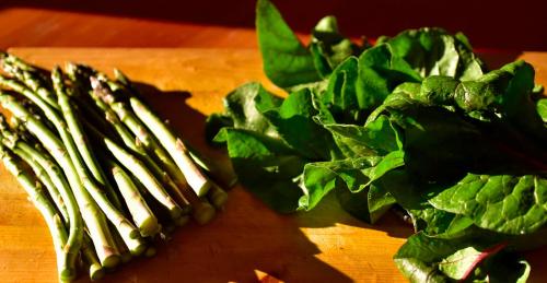 a bunch of green spinach on a cutting board at The Rockwell-Harrison Guest Lodge in Harrison Hot Springs