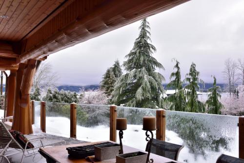 a winter view from a porch with a christmas tree at The Rockwell-Harrison Guest Lodge in Harrison Hot Springs