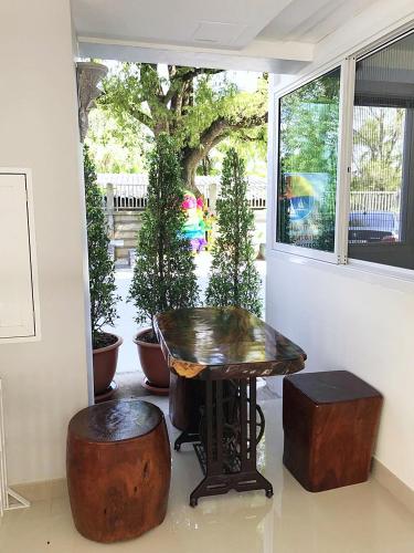 a table and two stools in front of a window at Sunrise Inn in Krabi