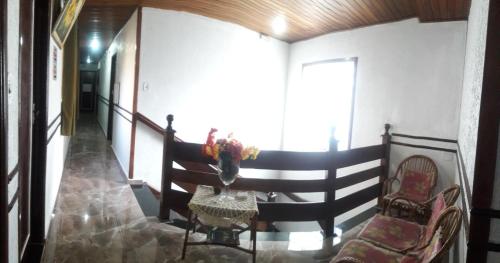 a room with a staircase with a chair and a table at Hotel Flor da Vila Mariana in Sao Paulo