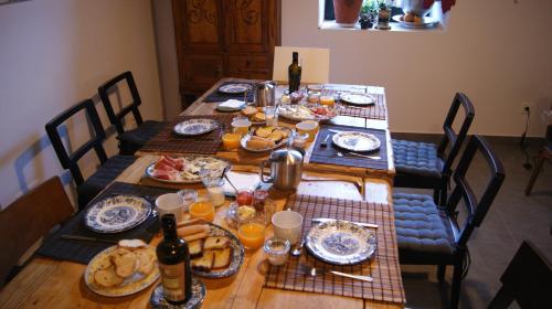 a table with food and bottles of wine on it at Hotel Rural Las Campares in Callejo de Ordás