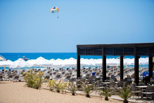 a group of chairs and umbrellas on a beach at Barut B Suites in Side