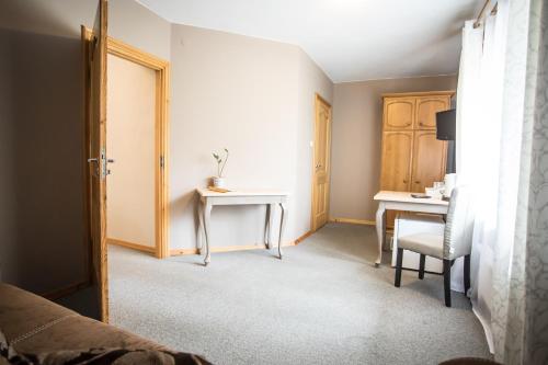 a bedroom with a desk and a table with a chair at Anielski Zakątek Polańczyk in Polańczyk