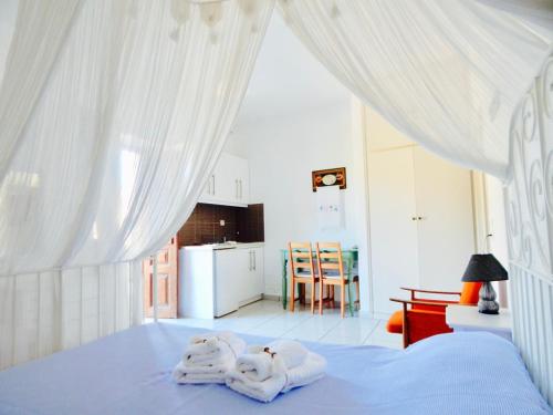 a bedroom with a bed with towels on it at Filio Apartments in Kámbos