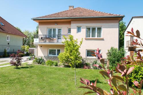 a house with a yard in front of it at Forestine Guesthouse in Hévíz