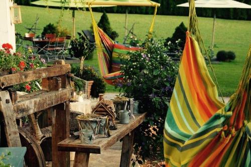 a group of hammocks in a garden with flowers at Hotel Ehrwalderhof in Ehrwald