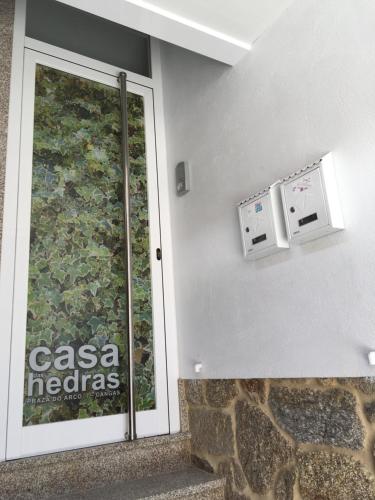 a sign on the side of a building with a glass door at Ático del Arco in Cangas de Morrazo