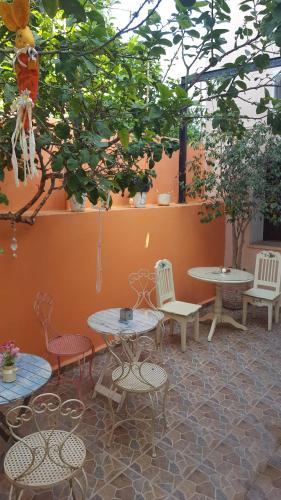 a patio with tables and chairs and trees at Studio Lefaki in Rethymno Town