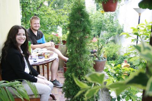 a man and a woman sitting at a table in a garden at Base for Adventurers - Urban Guerrilla in Negotin