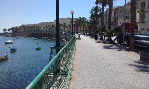 a bridge over a river with boats in the water at The April Maisonette in Marsaskala