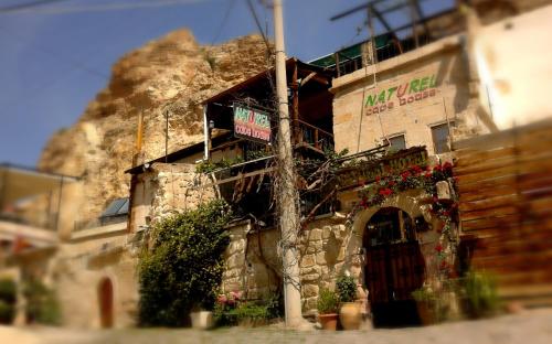 a building with a sign on the side of it at Naturels Cave House in Ürgüp