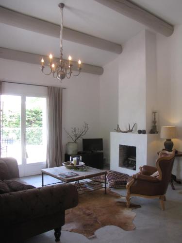 a living room with a couch and a table at "Le Vent d'Étoile" B&B and Guesthouses in Mormoiron