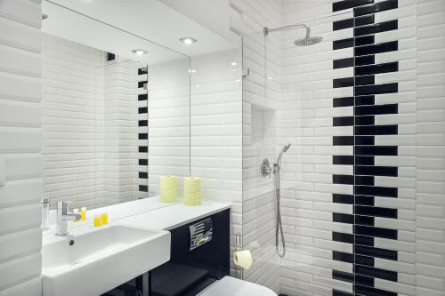 a bathroom with a sink and a toilet and a shower at Bednarska Old Town Apartment in Warsaw