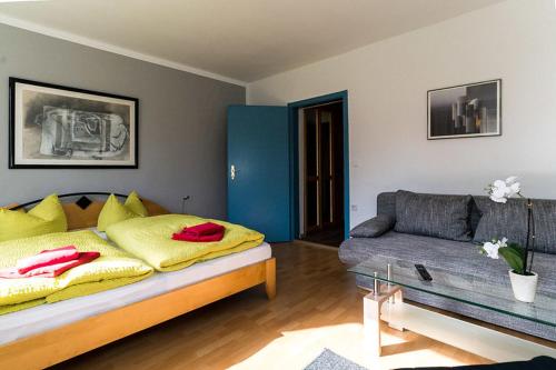 a living room with a bed and a couch at Landhotel Cafe Prälank in Neustrelitz