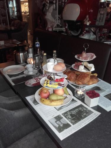 a table with many plates of food on it at Le Relais de Chassepierre in Chassepierre
