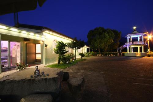a night view of a building with a lit up tower at Taitung Moon House in Luye