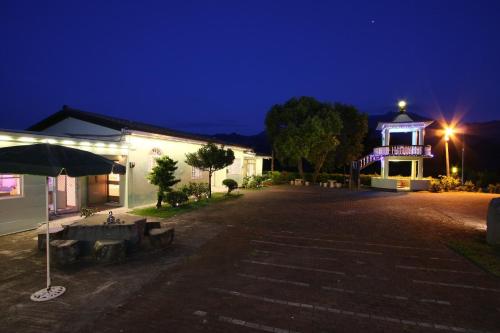 a building with a lit up gazebo at night at Taitung Moon House in Luye