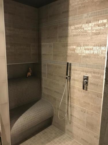 a shower with a bench in a bathroom at Le Relais de Chassepierre in Chassepierre