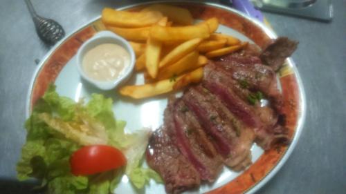 a plate of food with steak and french fries and sauce at Le Soleil D'or in Vimoutiers
