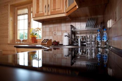 a kitchen with a sink and a counter top at Luxdomki in Szczawnica
