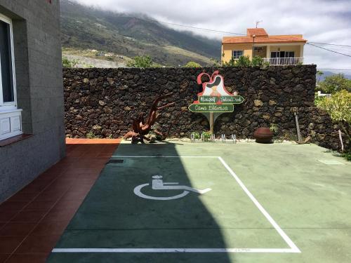 a man is on a tennis court on a court at Apartamentos Los Verodes in Frontera