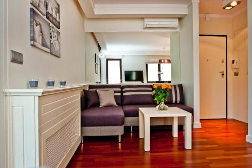a living room with a couch and a table at Villa Aqua BlueApart Jurata in Jurata
