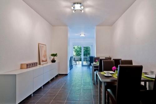 a dining room with tables and chairs and a room with a unintention at Bed & Breakfast BonnaNotte in Essen