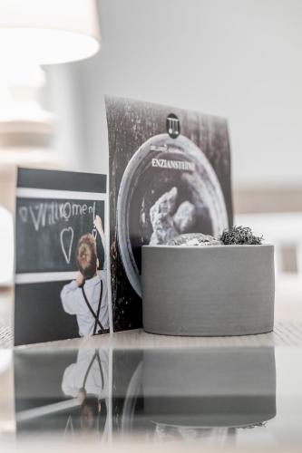 a glass table with a picture and a book on it at Genießerhotel Döllerer in Golling an der Salzach