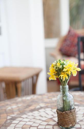 a vase filled with yellow flowers sitting on a table at The Langtons in Eastbourne
