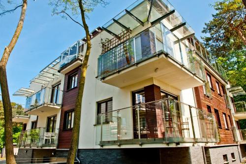 a building with a balcony on the side of it at Villa Aqua BlueApart Jurata in Jurata
