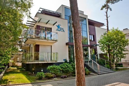 a building with a akoya sign on it at Villa Aqua BlueApart Jurata in Jurata