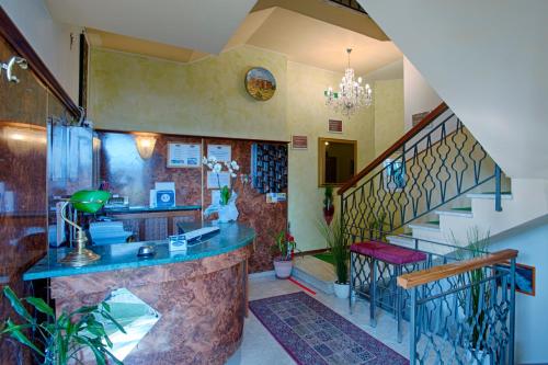 a kitchen with a counter and a staircase in a house at Locanda San Biagio in Misano Adriatico