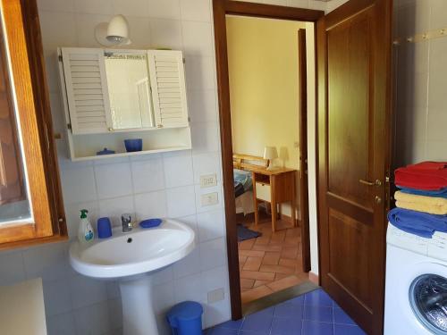 モンテ・サン・サヴィーノにあるVilla La Torricellaのバスルーム(シンク、洗濯機付)