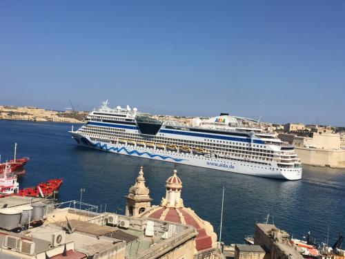 a cruise ship is docked in the water at Valletta Harbour View Apartment in Valletta