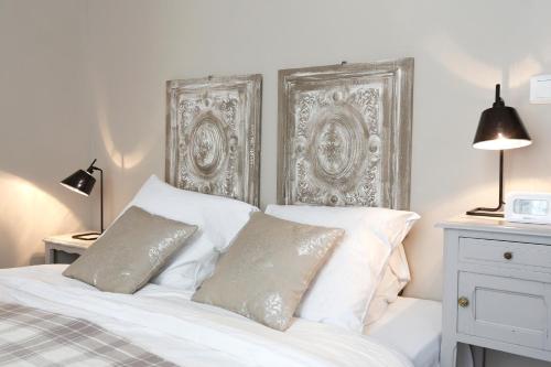 a white bed with white pillows and a silver headboard at Nature & Chateaux in Chinon