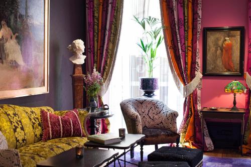 a living room with a couch and a chair at Dorsia Hotel & Restaurant in Gothenburg