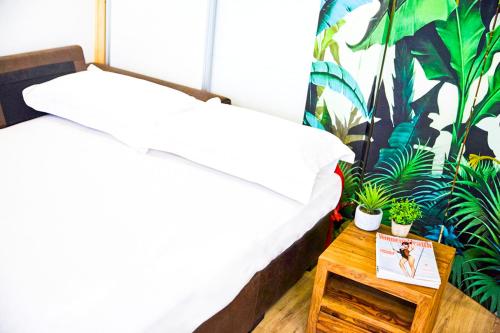 a bedroom with a bed and a table with plants at Center Sol Boutique in Madrid