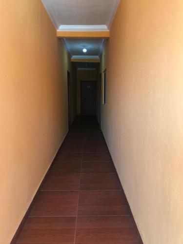 an empty hallway with a tile floor and a ceiling at Hotel Campo Real Plus Tamasopo in Tamasopo