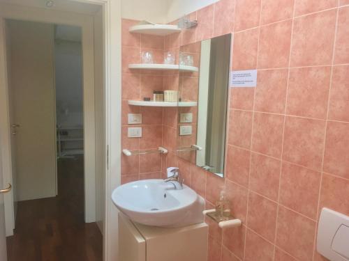 a bathroom with a sink and a mirror at B&B Griffoni 7 in Bologna