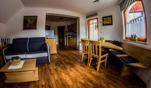 a living room with a couch and a table at Apartments BBI in Luče