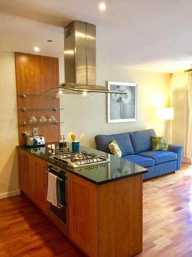 a kitchen with a stove and a blue couch at Edinburgh Old Town in Edinburgh
