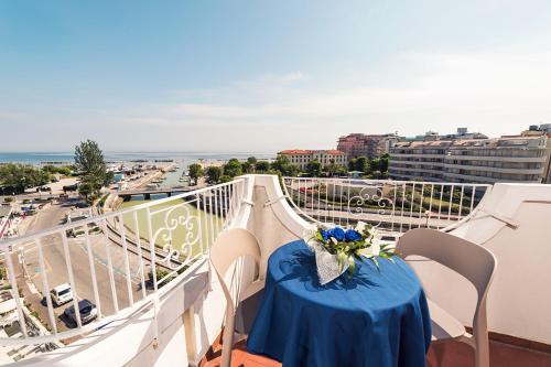 a table with a blue table cloth on a balcony at Hotel Alexander in Cattolica