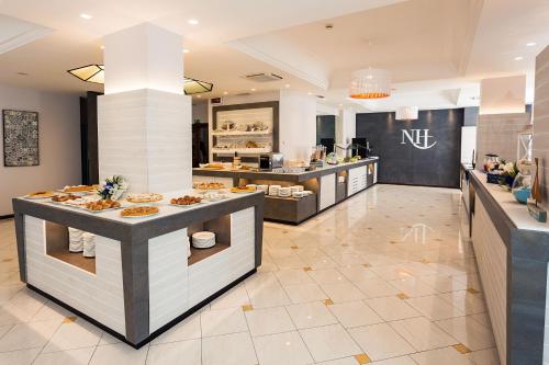 a restaurant with a buffet line with food at Hotel Alexander in Cattolica