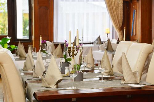 a long table with napkins and candles on it at Villa Oranien in Diez