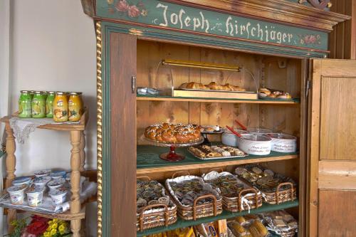 a display cabinet filled with different types of food at Hotel Villa Alpina ***S in Cortina dʼAmpezzo
