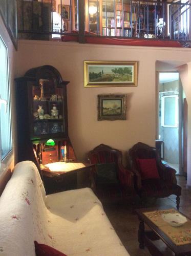 a living room with two chairs and a couch at Anastasia's Cottage in Oikhalía