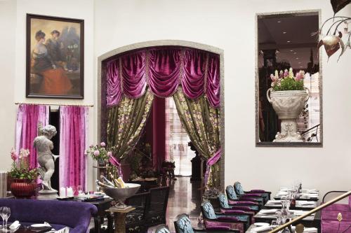 a dining room with purple drapes and tables at Dorsia Hotel & Restaurant in Gothenburg