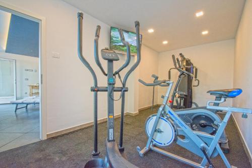 a gym with two exercise bikes and a tv at Apartments Bego Spa & Wellness in Crikvenica