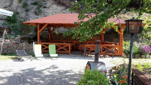 a wooden gazebo with chairs and a table at Gästehaus Gerhardt in Schweigen-Rechtenbach